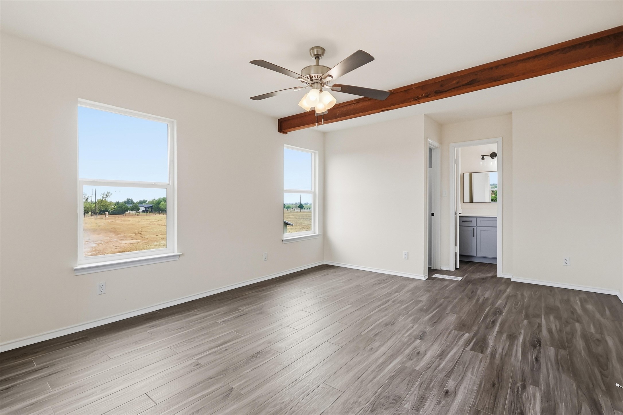 13201 Jacobson Road Manor, TX 78653 - Photo 13 of 25 a view of an empty room with wooden floor and a window