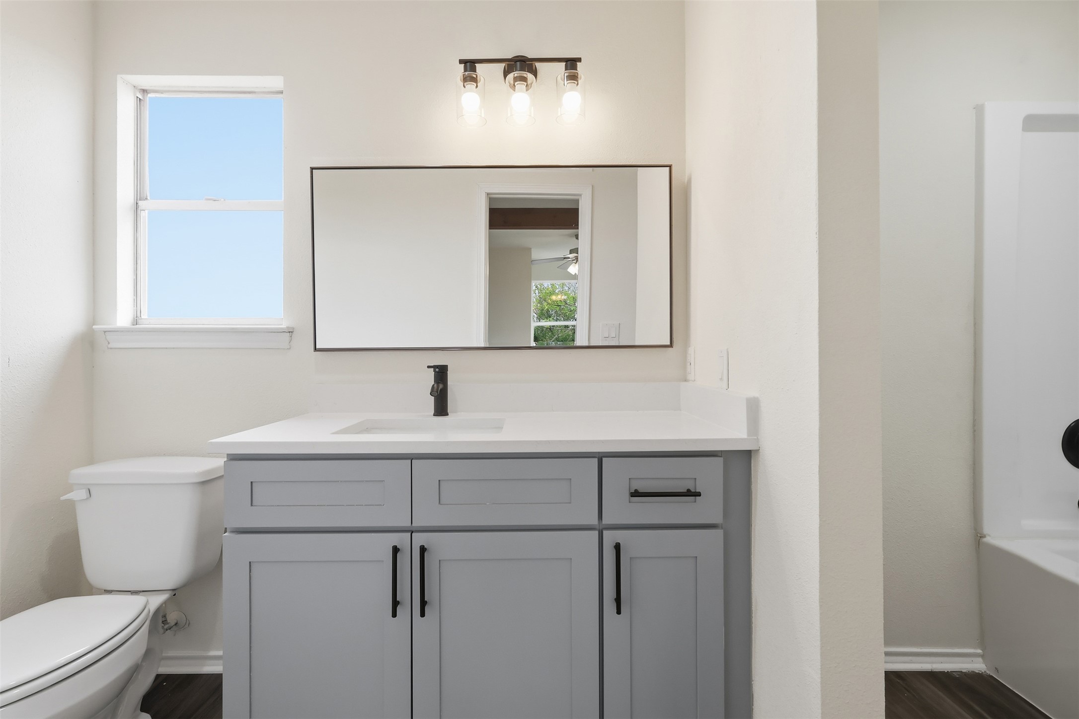 13201 Jacobson Road Manor, TX 78653 - Photo 22 of 25 a bathroom with a toilet sink and mirror
