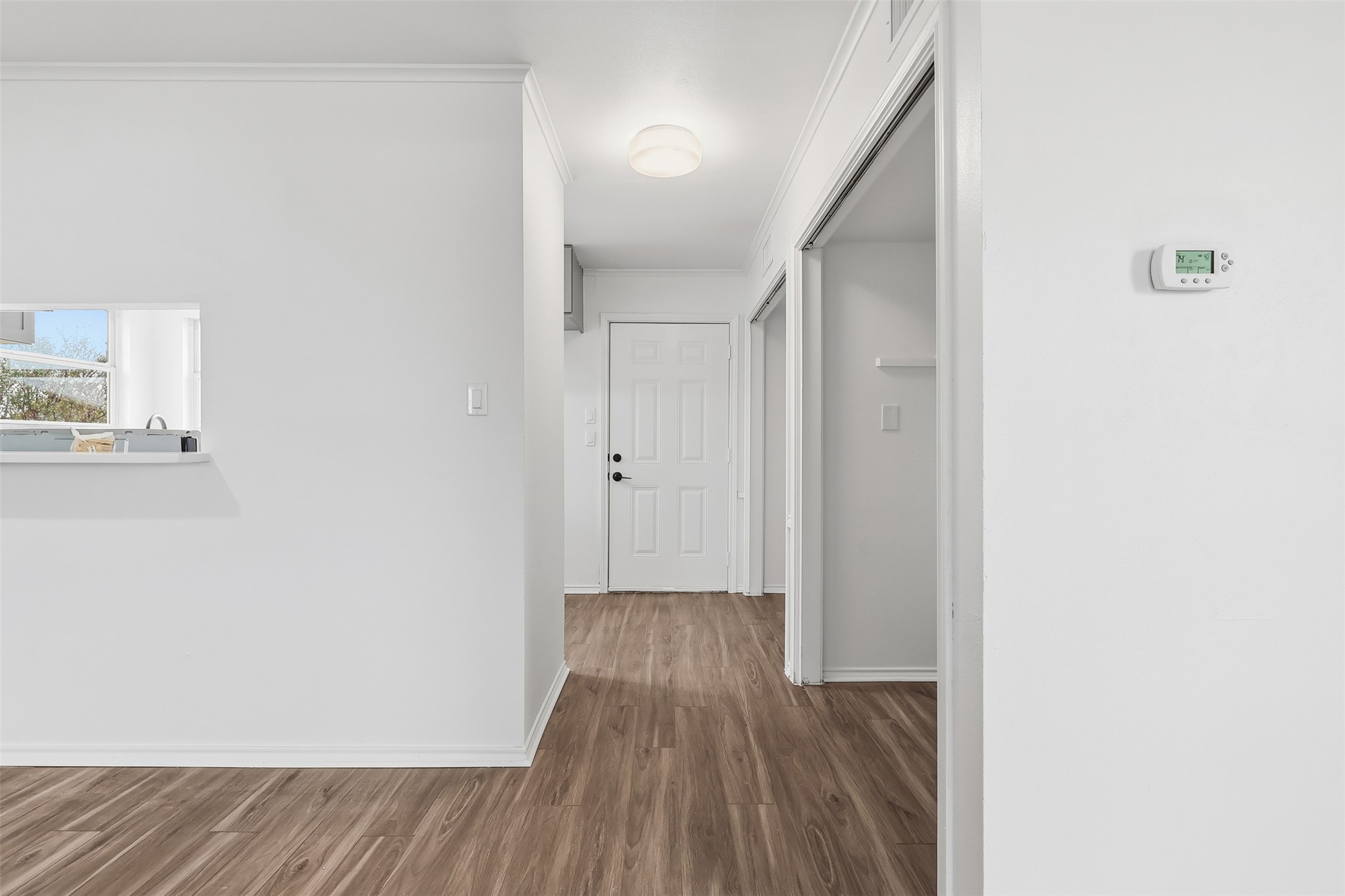 13201 Jacobson Road Manor, TX 78653 - Photo 4 of 25 a view of a hallway with wooden floor