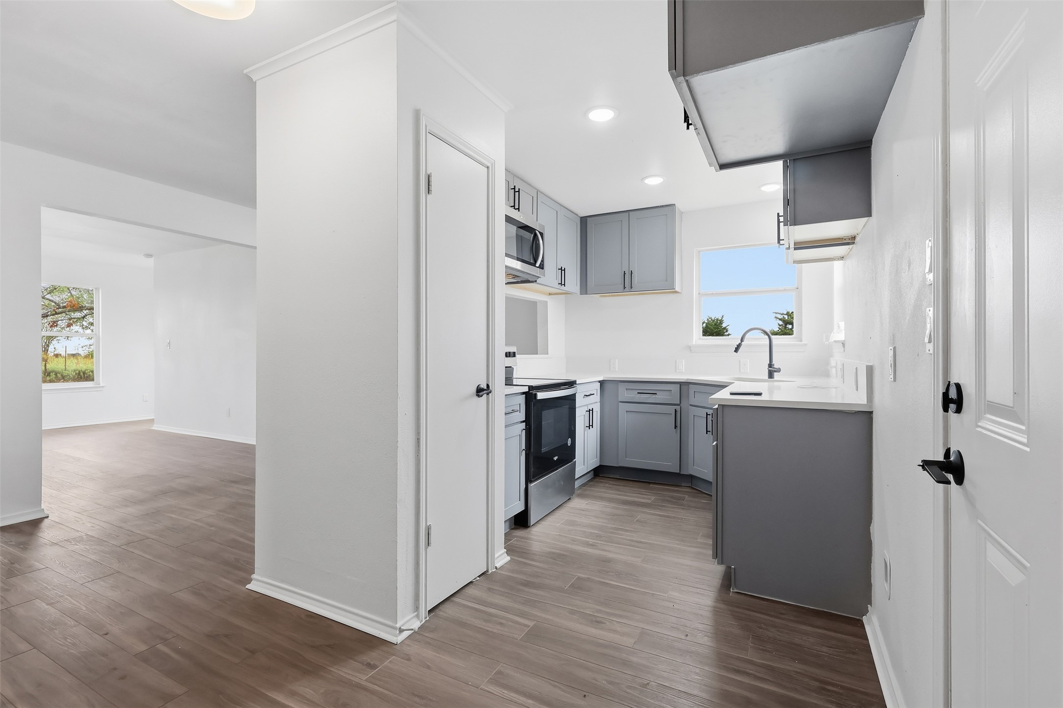 13201 Jacobson Road Manor, TX 78653 - Photo 5 of 25 a kitchen with a sink a counter top space stainless steel appliances and cabinets