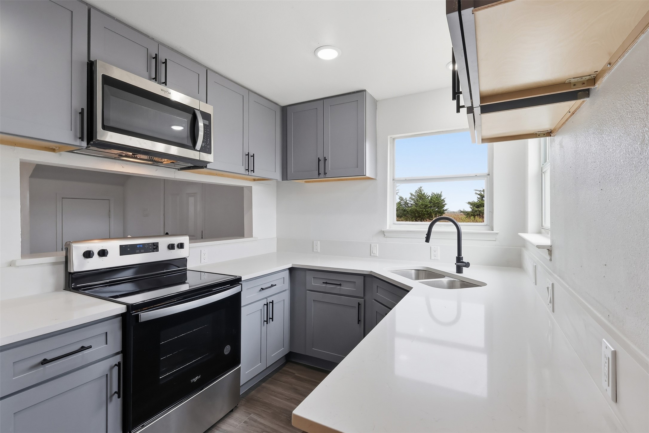 13201 Jacobson Road Manor, TX 78653 - Photo 6 of 25 a kitchen with a stove and a microwave