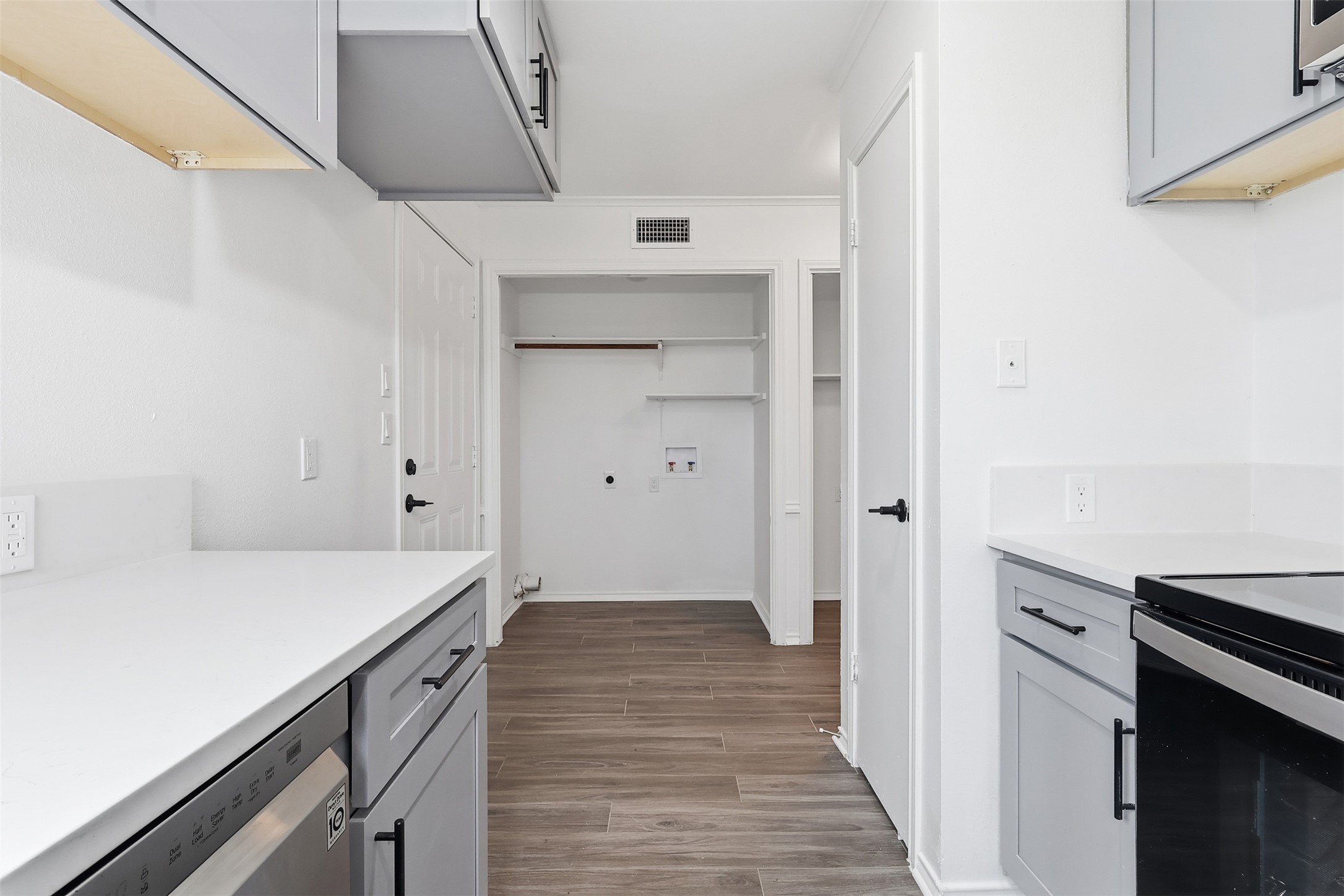 13201 Jacobson Road Manor, TX 78653 - Photo 7 of 25 a kitchen with a stove and a refrigerator