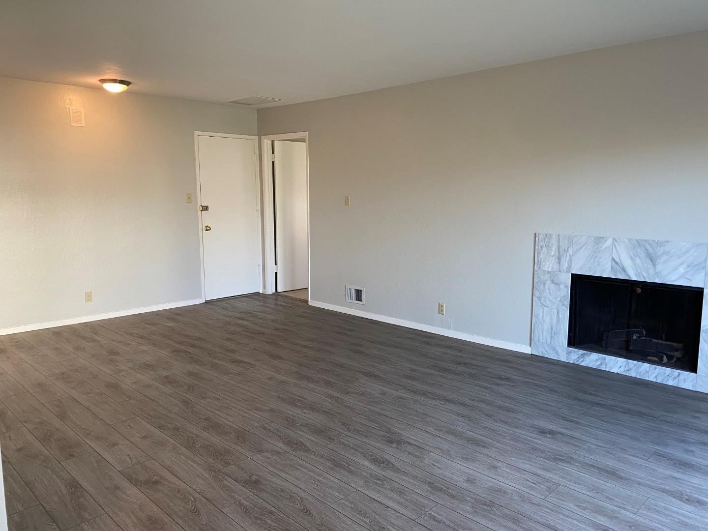 625 Comet Drive Foster City, CA 94404 - Photo 6 of 14 a view of empty room with wooden floor and fireplace