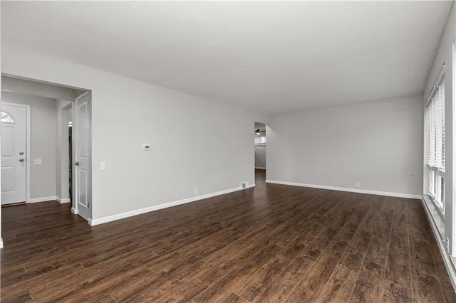 a view of an empty room and wooden floor