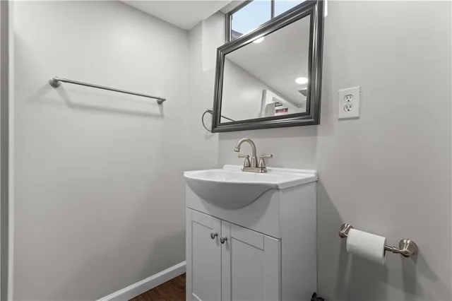 a bathroom with a sink a mirror and vanity
