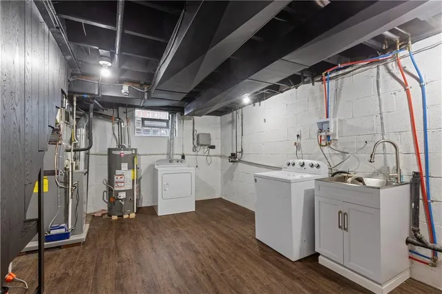 a kitchen that has a lot of white cabinets and wooden floor