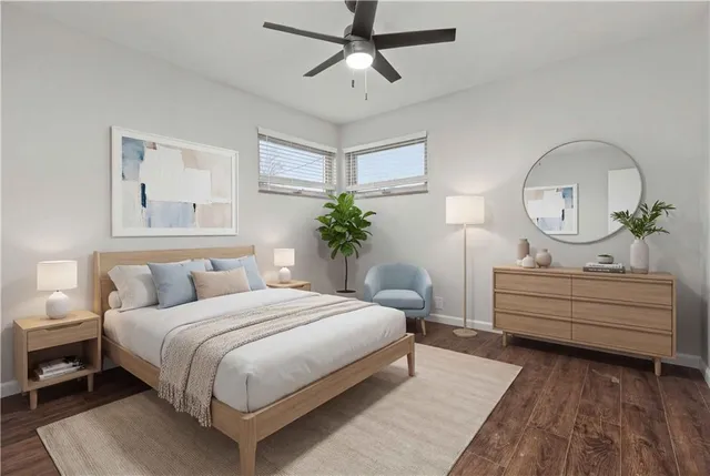 a bedroom with a bed mirror and window