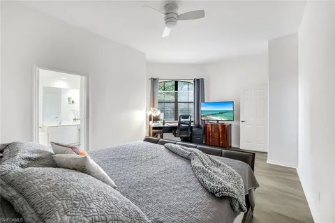 a bedroom with furniture and a large window