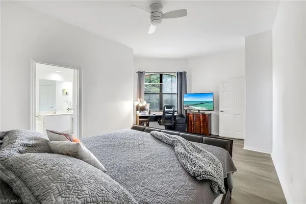 a bedroom with furniture and a large window