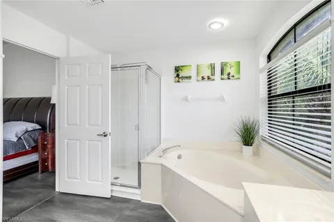 a bathroom with a tub shower and a sink
