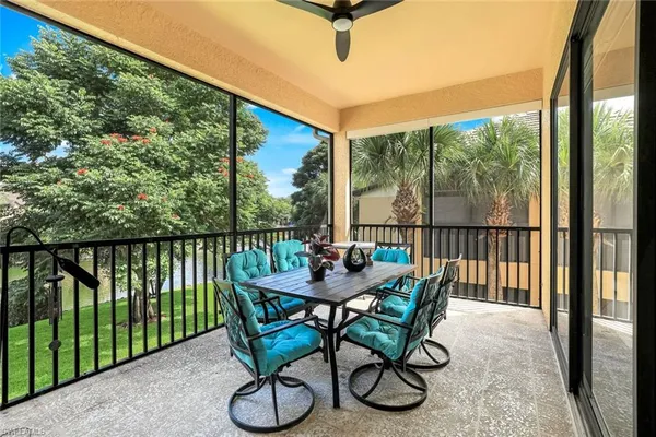 a dining room with furniture and a floor to ceiling window
