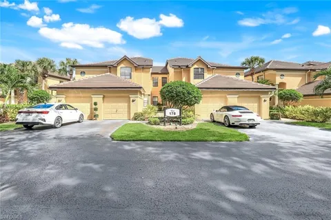 a front view of a house with a garden and parking space