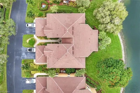 an aerial view of a house with a garden and trees all around