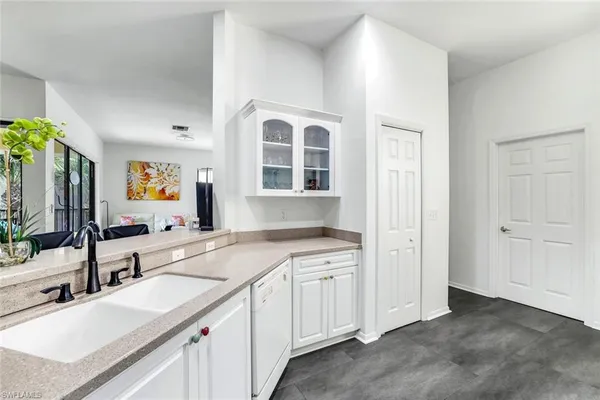 a kitchen with a sink stove and cabinets