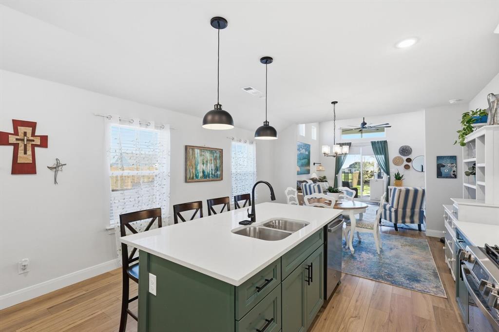 1018 Abigail Way Midlothian, TX 76065 - Photo 12 of 26 a kitchen with granite countertop a sink a counter space appliances and cabinets