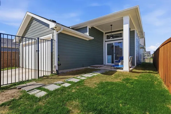 a backyard of a house with table and chairs