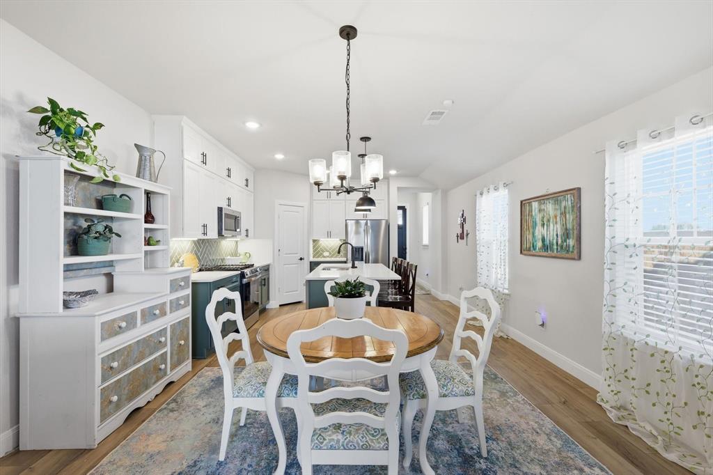 1018 Abigail Way Midlothian, TX 76065 - Photo 7 of 26 a view of a dining room with furniture window and wooden floor