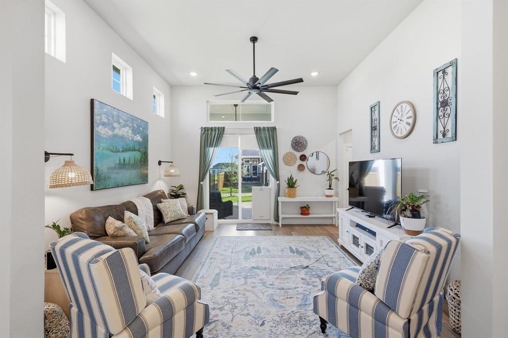 1018 Abigail Way Midlothian, TX 76065 - Photo 8 of 26 a living room with furniture a flat screen tv and a chandelier