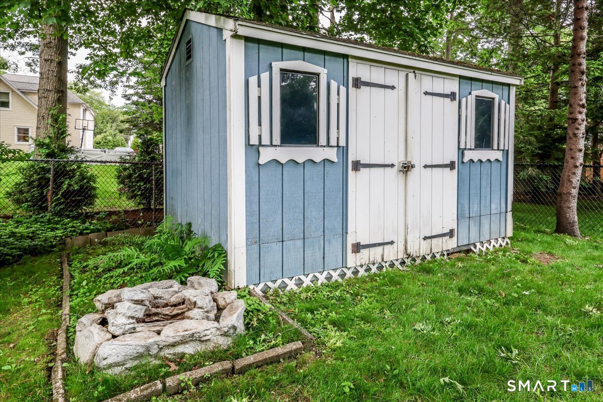 75 Centerbrook Road Fairfield, CT 06824 - Photo 37 of 39 Shed in back with a fire pit next to it.