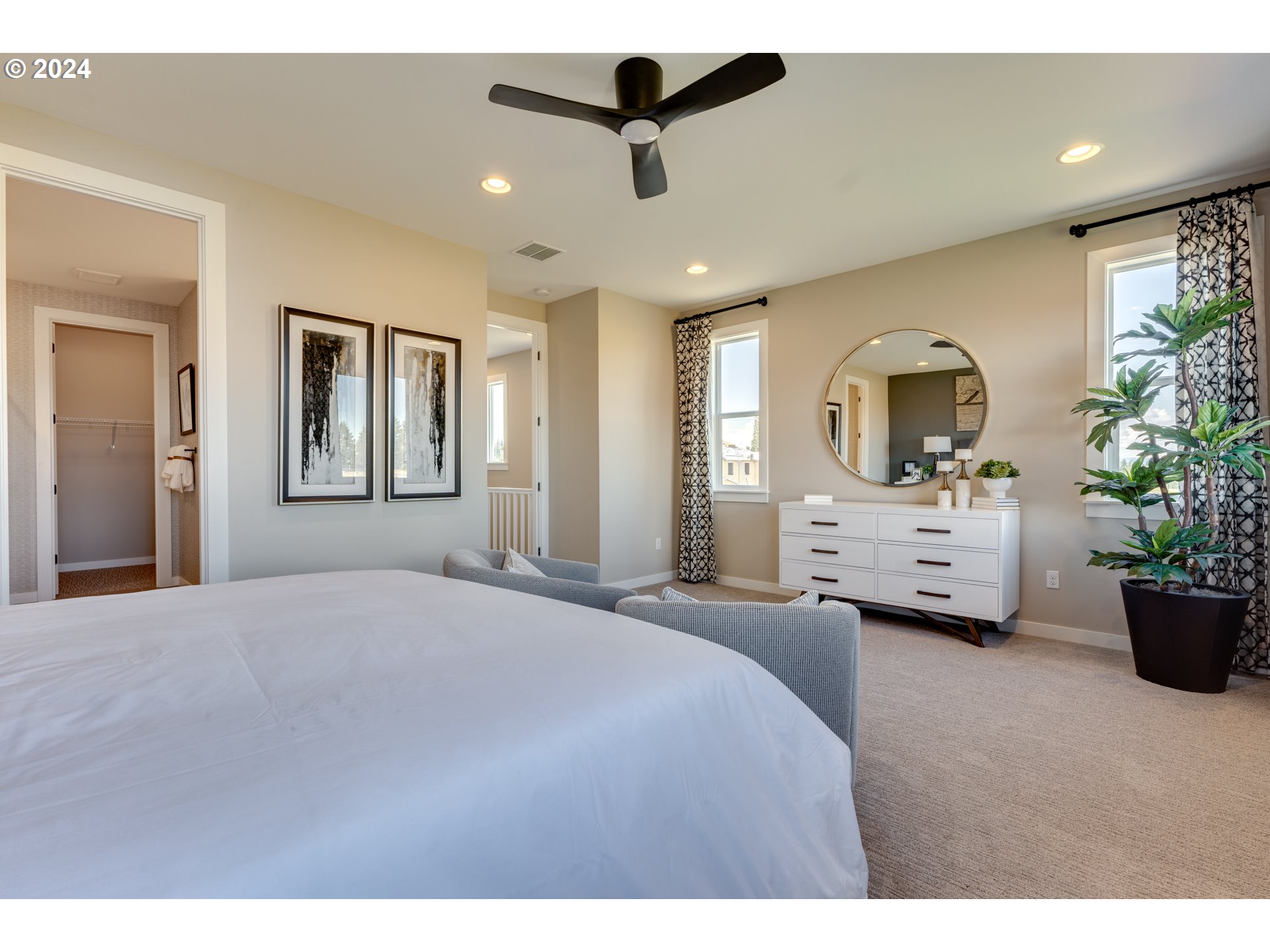 842 Northwest 178th Street Ridgefield, WA 98642 - Photo 22 of 46 a spacious bedroom with a large bed a chandelier and a window