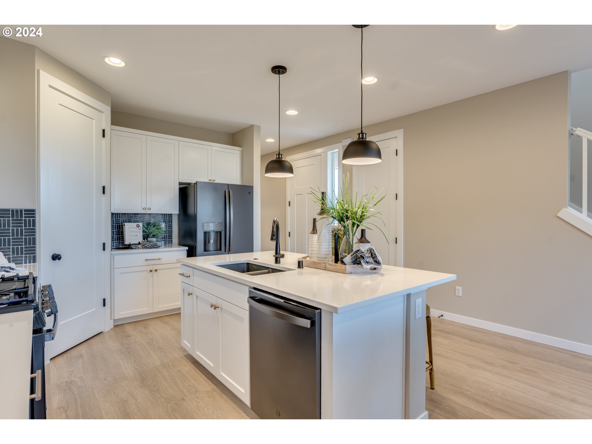 842 Northwest 178th Street Ridgefield, WA 98642 - Photo 3 of 46 a kitchen with a sink a stove a refrigerator and cabinets