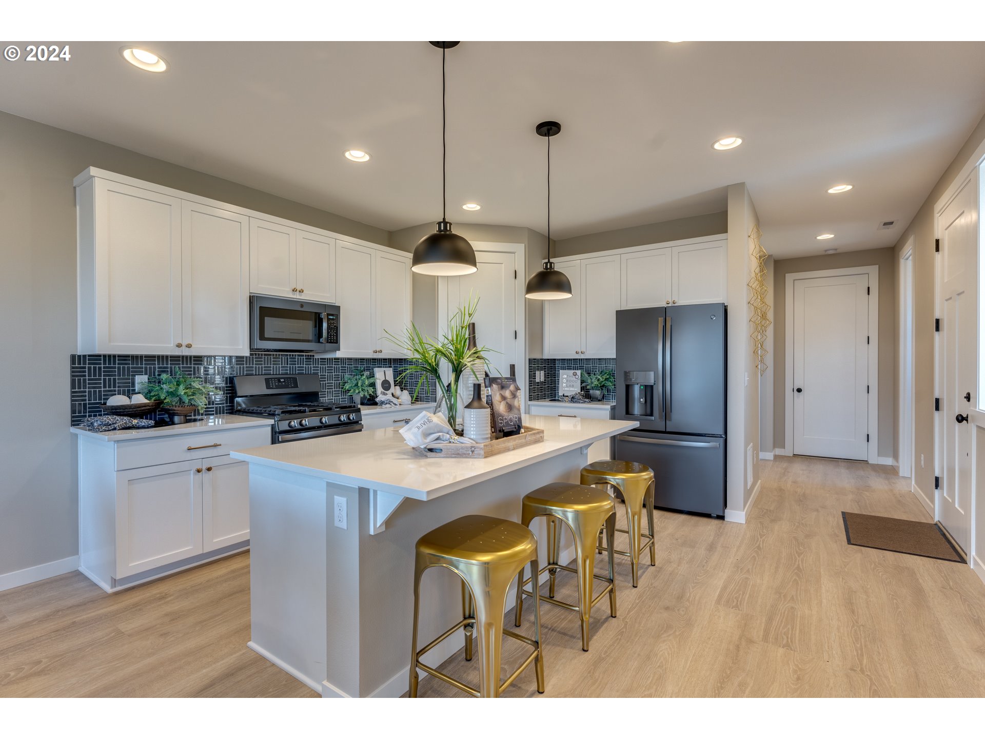 842 Northwest 178th Street Ridgefield, WA 98642 - Photo 34 of 46 a kitchen with stainless steel appliances kitchen island granite countertop a sink refrigerator and cabinets