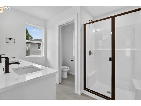 a bathroom with a double vanity sink a mirror and shower
