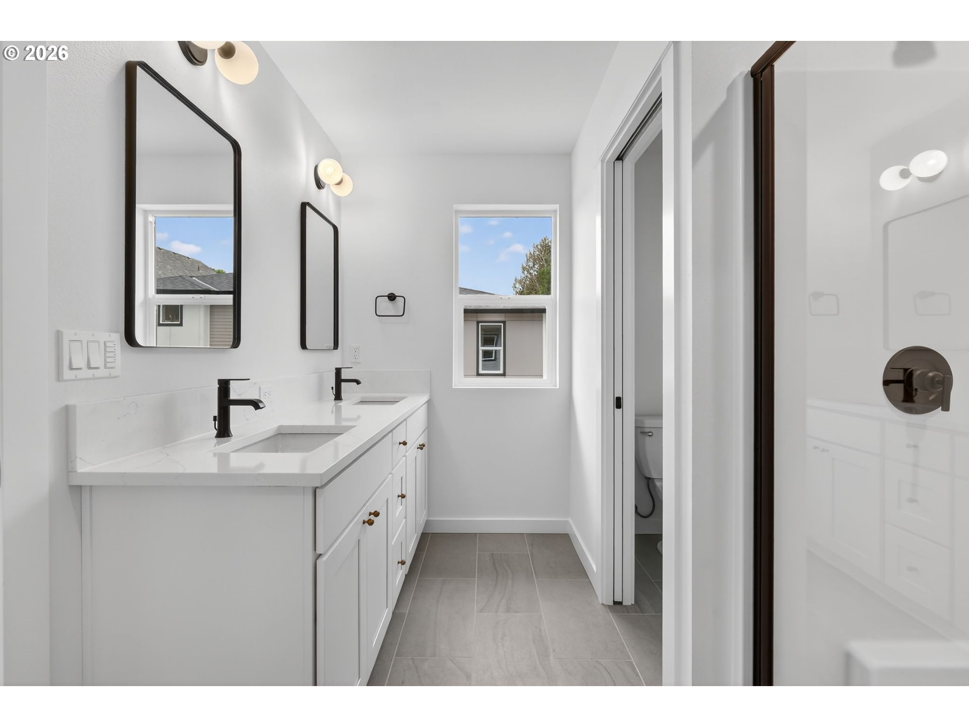 4055 Southwest McKinley Street, Unit 39 Gresham, OR 97080 - Photo 21 of 35 a bathroom with a double vanity sink a mirror and shower