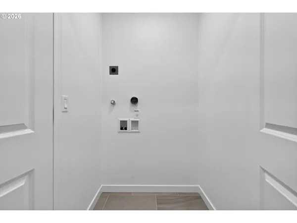 a kitchen with stainless steel appliances granite countertop a sink a stove and a refrigerator with wooden floor