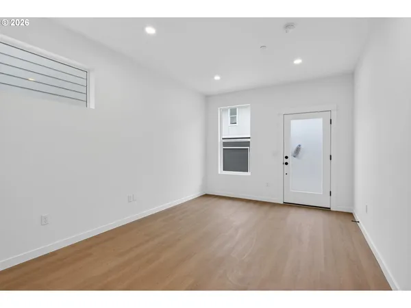 a view of empty room with wooden floor