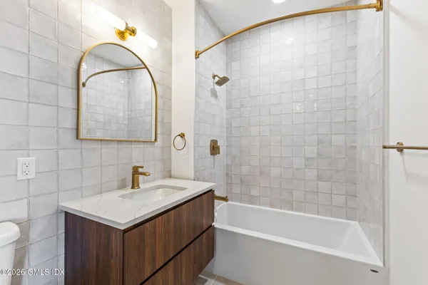 a front view of a residential apartment building with a yard