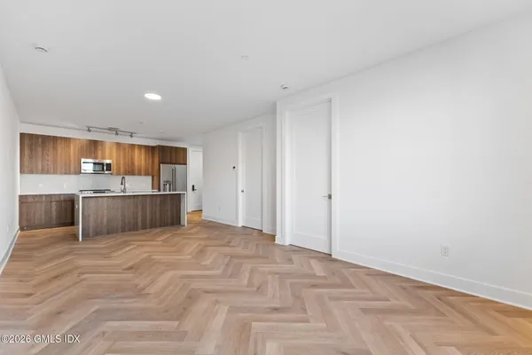 an empty room with a window and a mirror