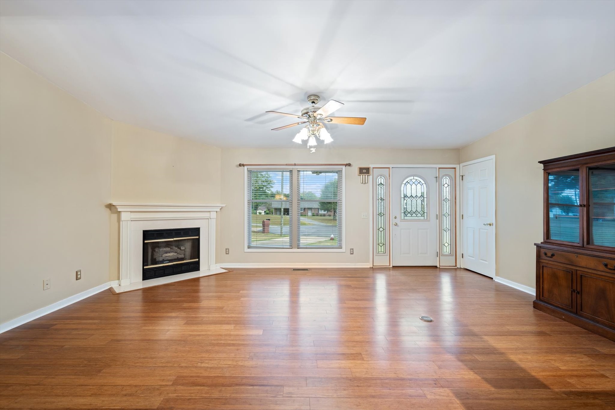 106 Lee Drive Springfield, TN 37172 - Photo 7 of 25 an empty room with fireplace chandelier fan and windows