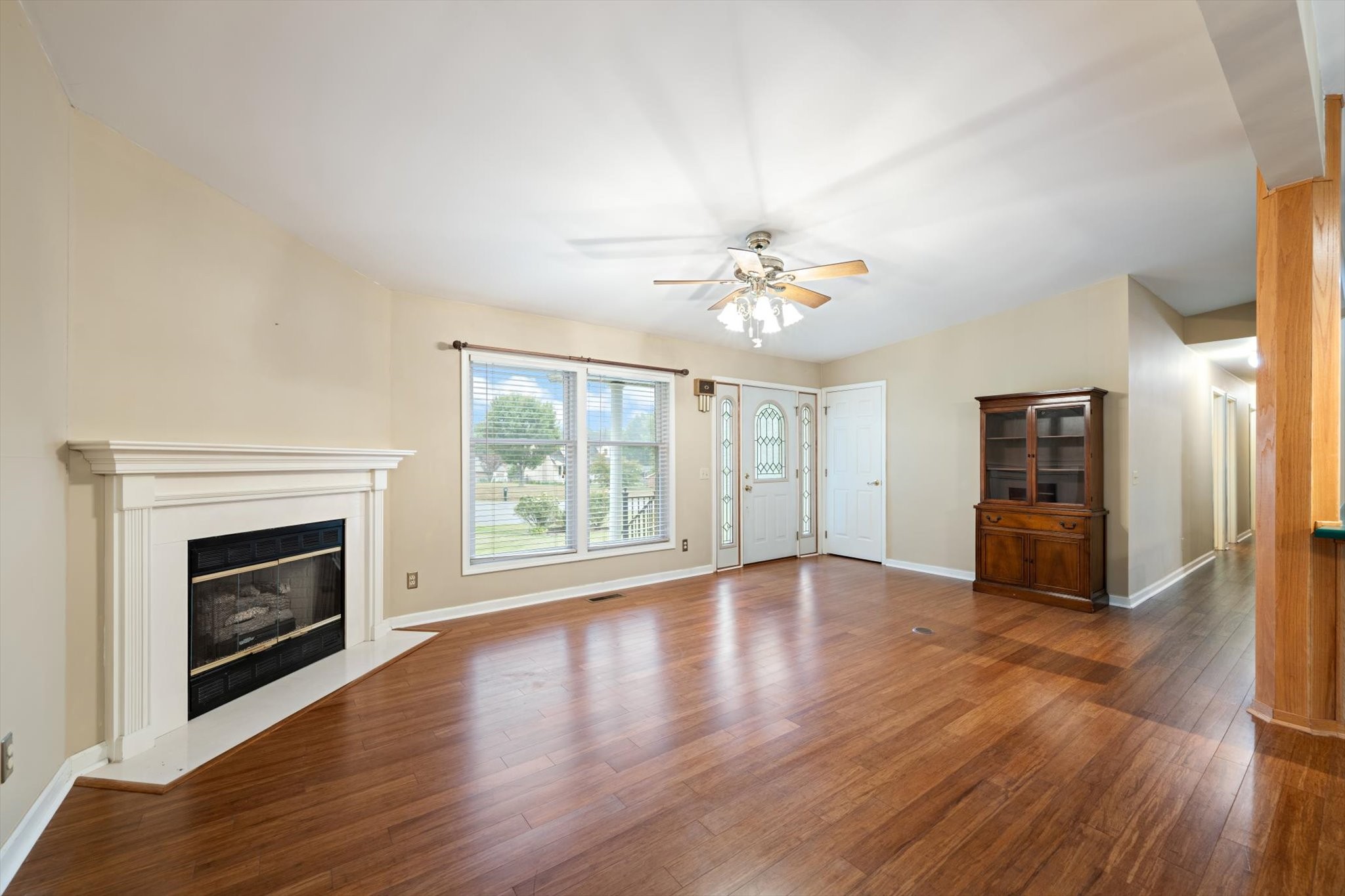106 Lee Drive Springfield, TN 37172 - Photo 8 of 25 a view of an empty room with wooden floor fireplace and a window