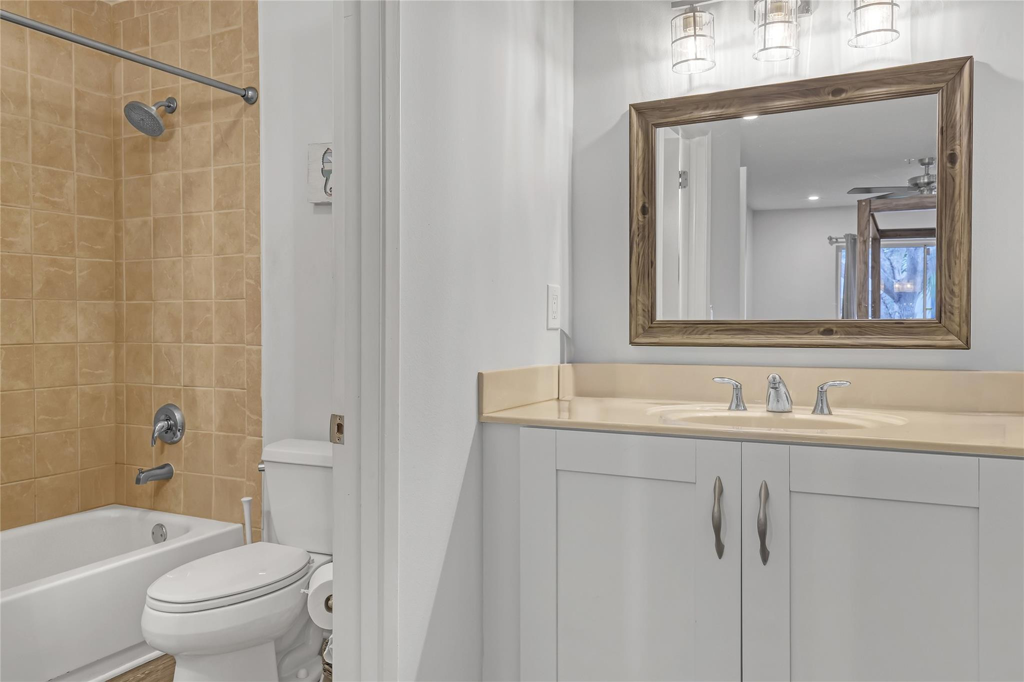 3143 Clint Moore Road, Unit 205 Boca Raton, FL 33496 - Photo 14 of 27 a bathroom with a granite countertop toilet a sink and a mirror