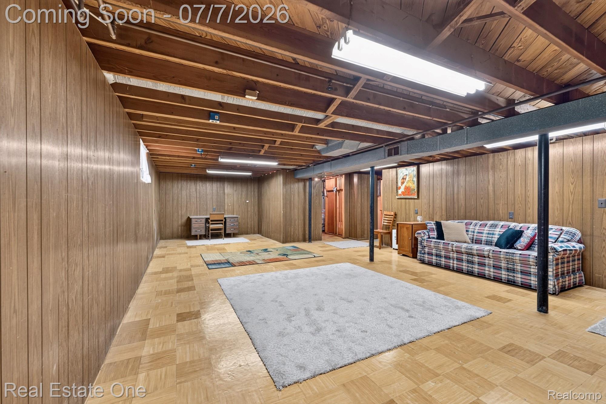24749 Munson Street Taylor, MI 48180 - Photo 18 of 28 Lower level featuring wood paneling, exposed wood beam ceiling, tiled flooring, and fluorescent lighting fixtures