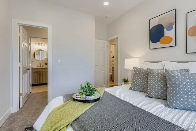 a living room with furniture and painting on the wall