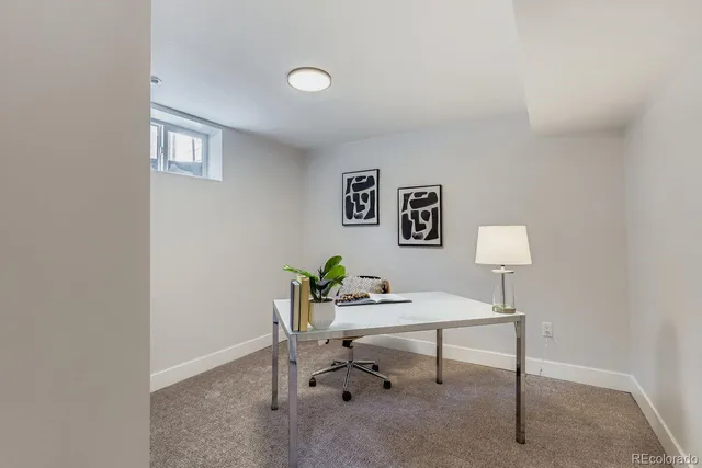 a view of a workspace with furniture and a lamp