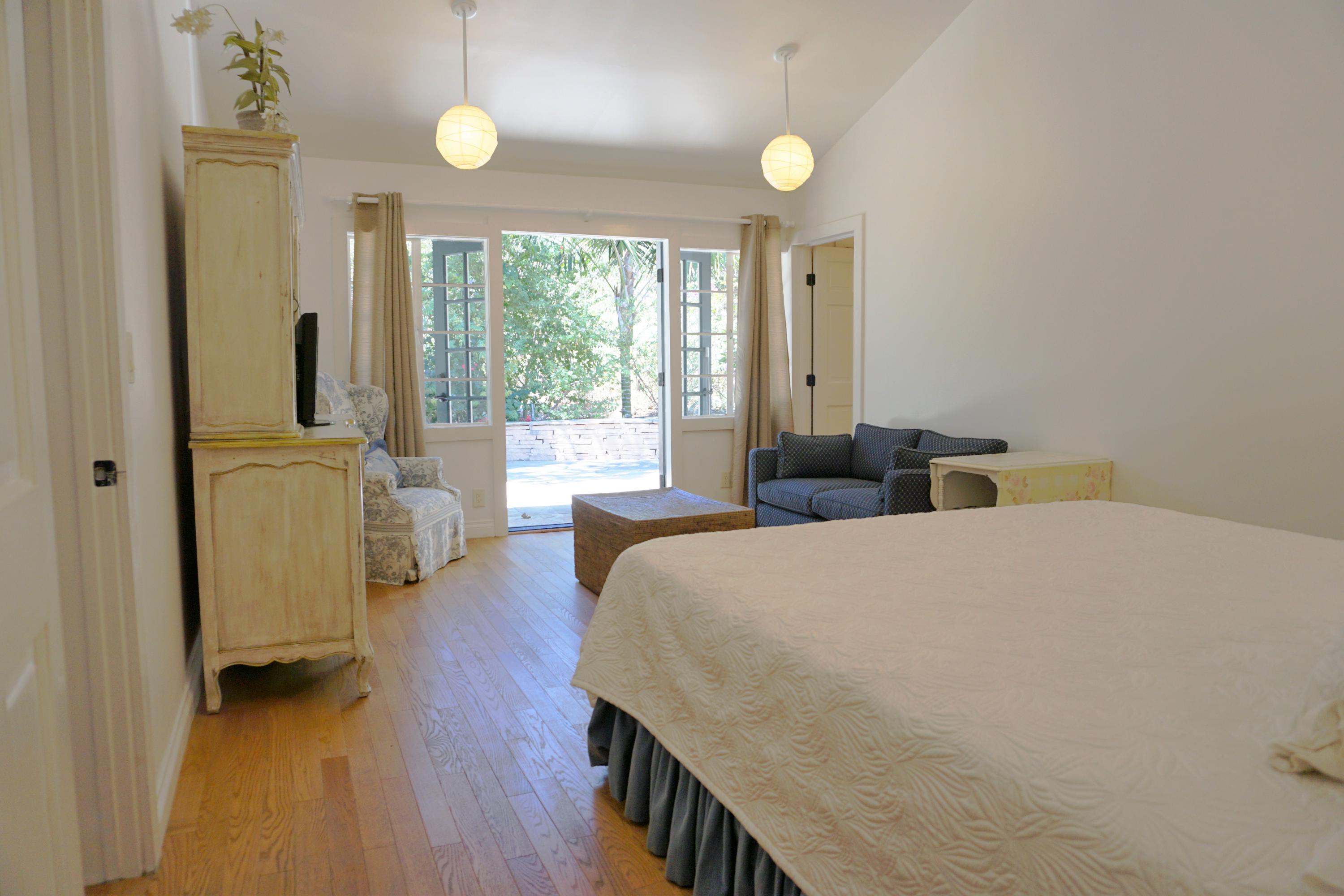 220 Olive Mill Road Santa Barbara, CA 93108 - Photo 2 of 6 a bedroom with a bed and wooden floor
