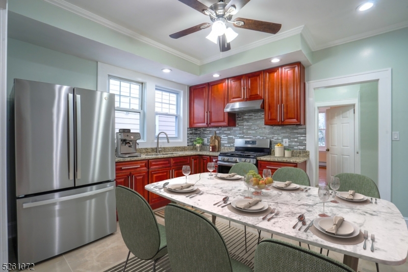 a kitchen with stainless steel appliances granite countertop a sink refrigerator stove and microwave