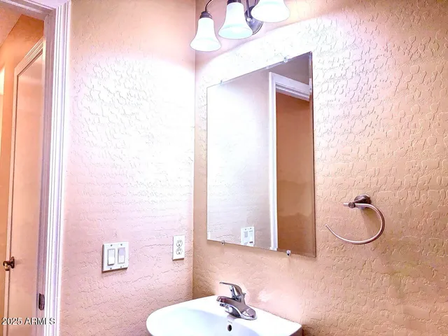 a bathroom with a sink a mirror and a shower