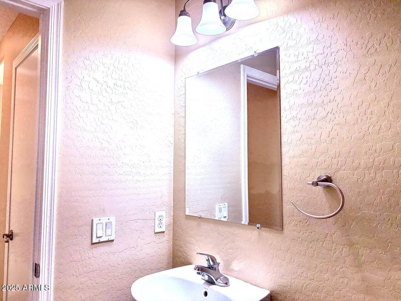 4014 East Superior Road San Tan Valley, AZ 85143 - Photo 17 of 36 a bathroom with a sink a mirror and a shower