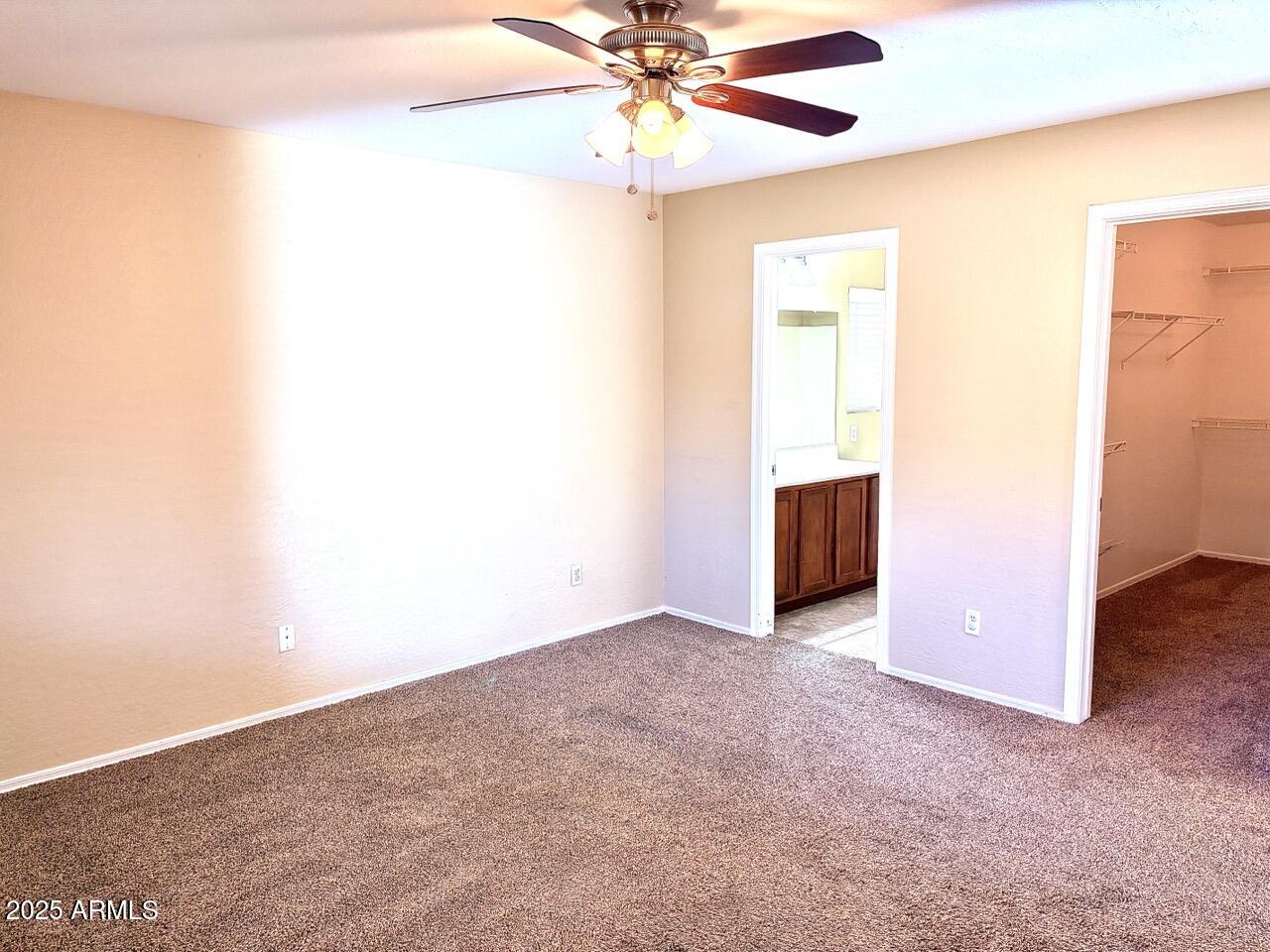 4014 East Superior Road San Tan Valley, AZ 85143 - Photo 19 of 36 an empty room with chandelier fan and windows