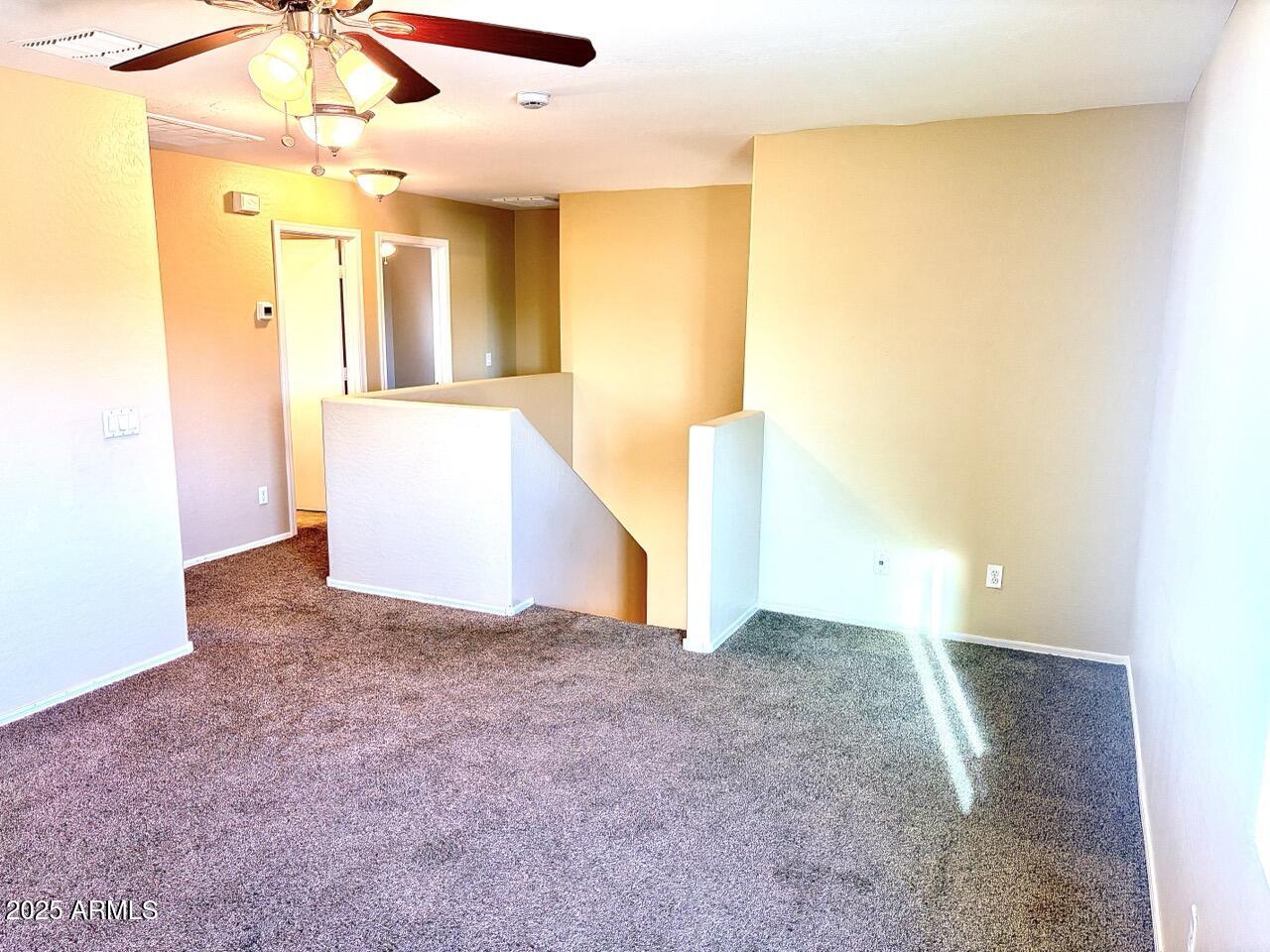 4014 East Superior Road San Tan Valley, AZ 85143 - Photo 24 of 36 a view of a big room with windows and chandelier fan