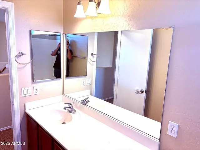 a bathroom with a sink and a mirror