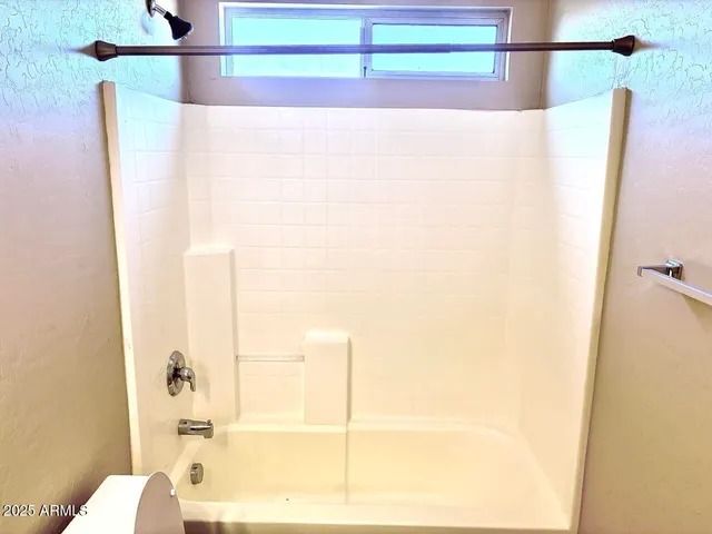 a bathroom with a bathtub and a shower