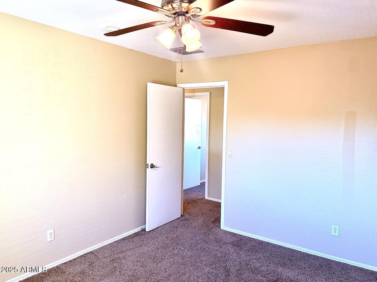 4014 East Superior Road San Tan Valley, AZ 85143 - Photo 33 of 36 an empty room with a ceiling fan and a window