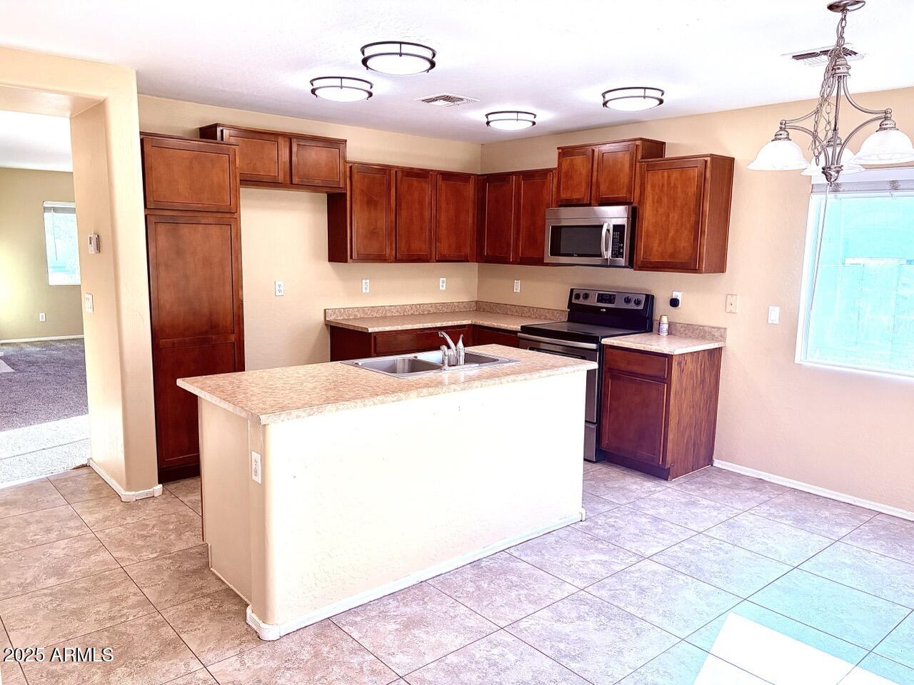 4014 East Superior Road San Tan Valley, AZ 85143 - Photo 6 of 36 a kitchen with stainless steel appliances granite countertop a stove a sink and a refrigerator