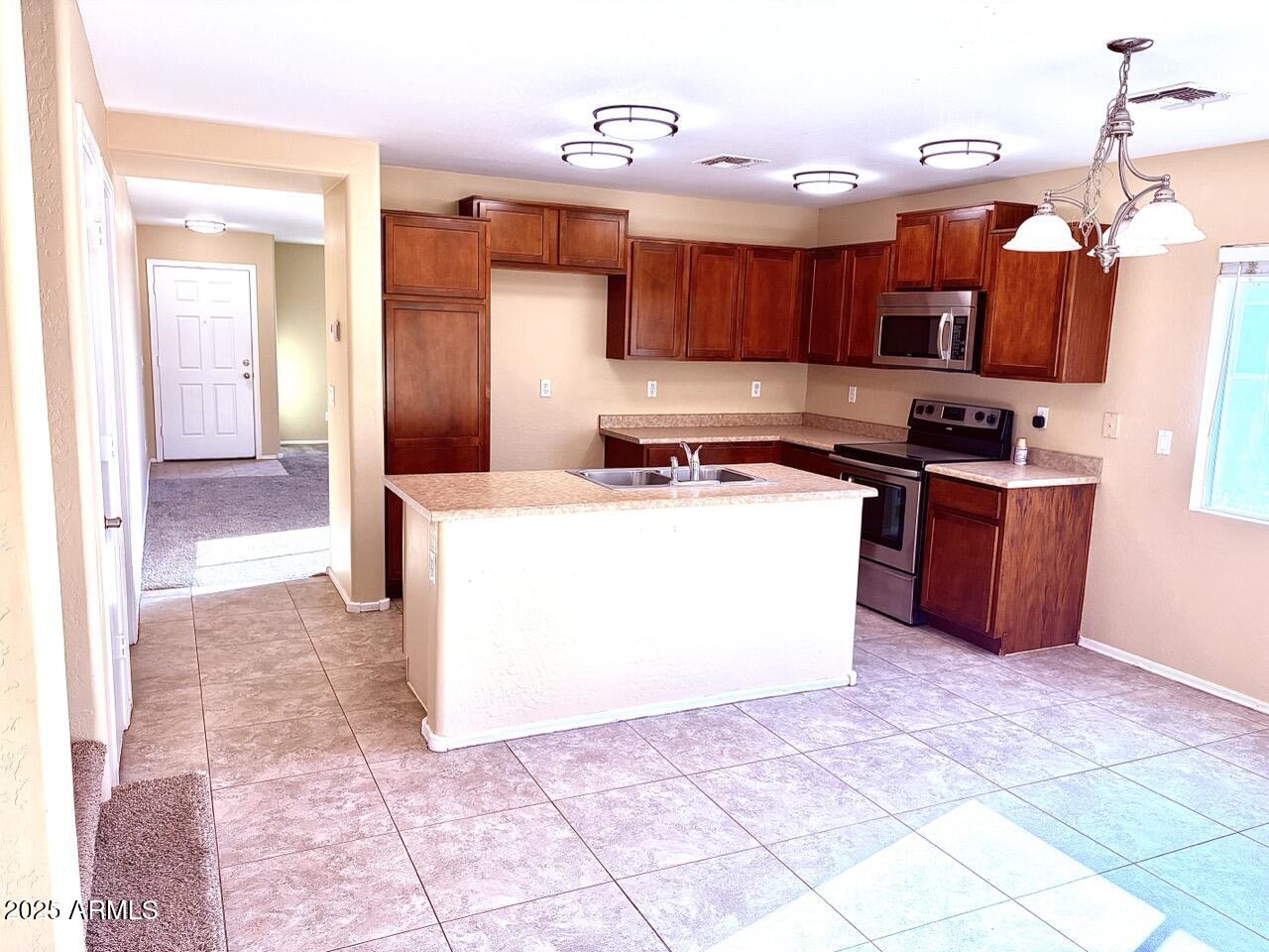 4014 East Superior Road San Tan Valley, AZ 85143 - Photo 8 of 36 a kitchen with stainless steel appliances granite countertop a stove a sink dishwasher and a refrigerator