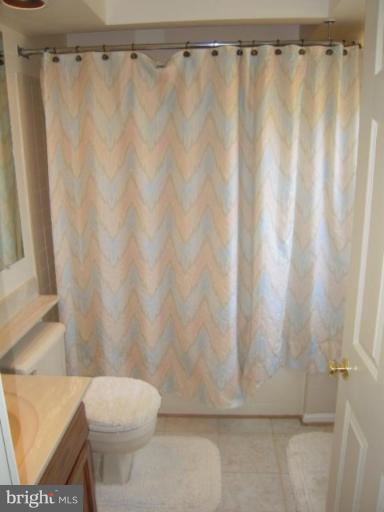 2002 Inland Loop Woodbridge, VA 22192 - Photo 22 of 30 a white toilet sitting next to a shower curtain